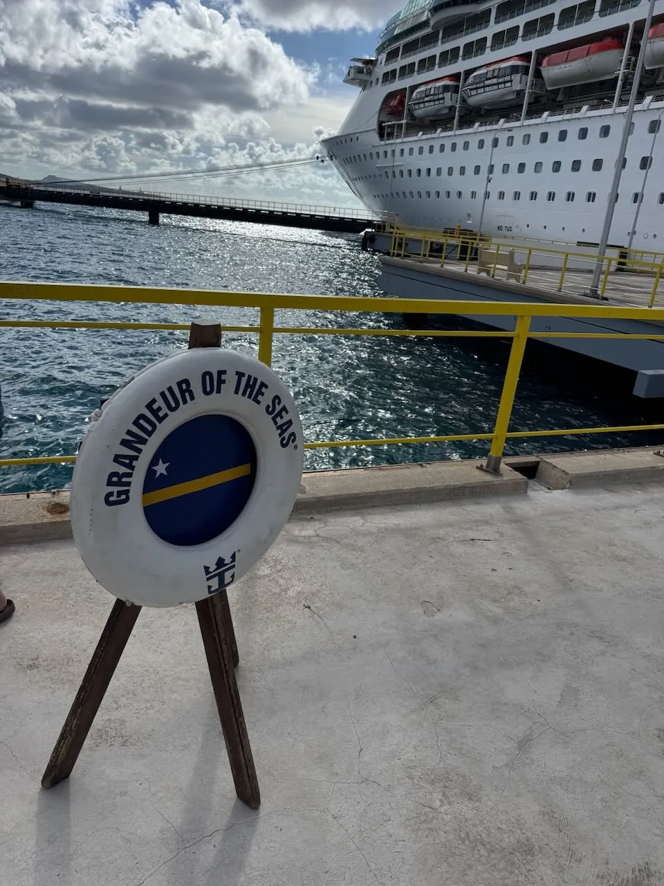 Grandeur of the Seas life ring with Royal Caribbean cruise ship docked at Curacao